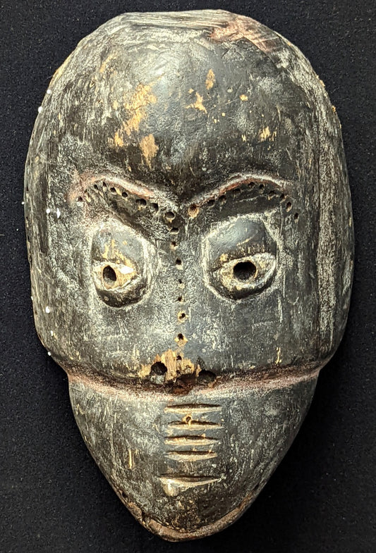 A Nigerian Ibibio African tribal carved wooden mask