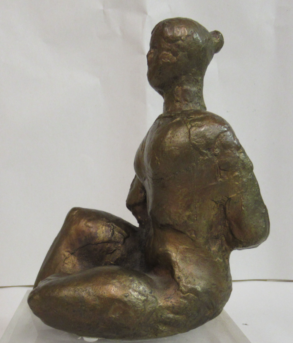 Seated woman on a perspex plinth